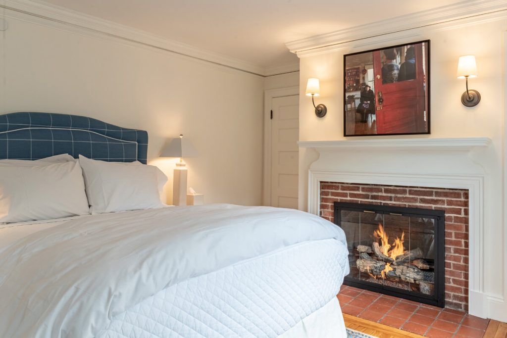 Bed and fireplace in The Fireplace Room in Westerly, RI