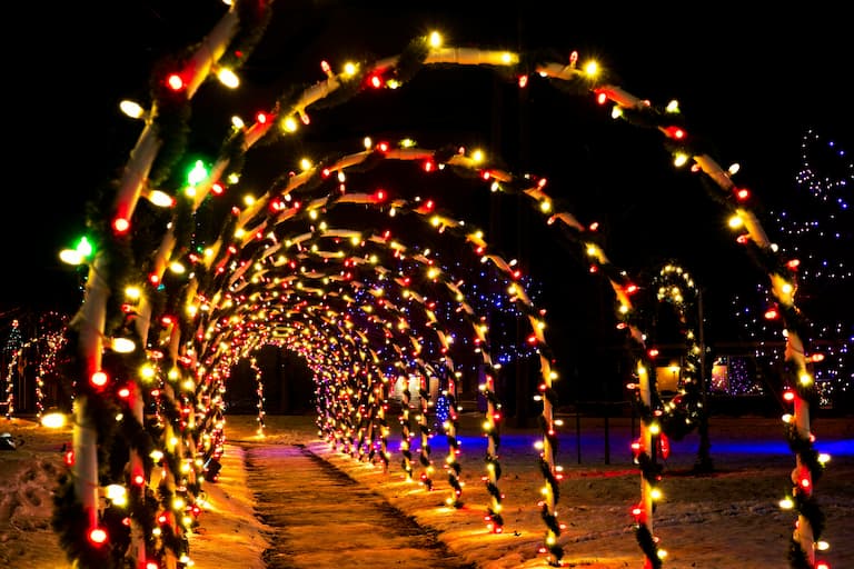 A display of arched Christmas lights in Rhode Island over a sidewalk