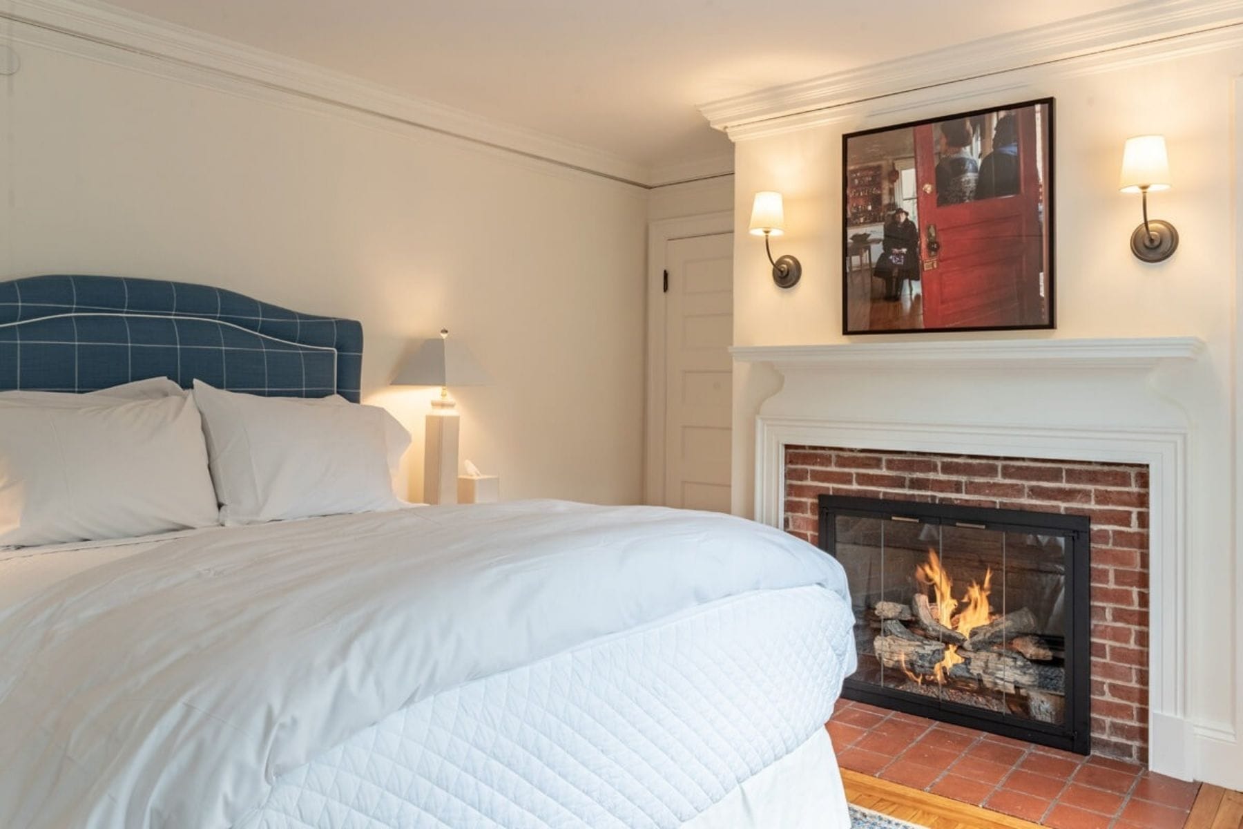 A bedroom with a lit fireplace at our bed and breakfast during a Romantic Getaway in New England
