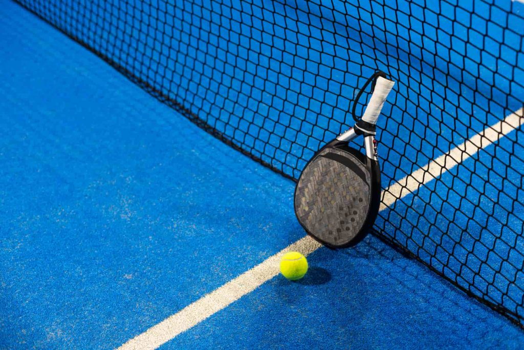 A padel racquet and ball on a padel court in Westerly, RI