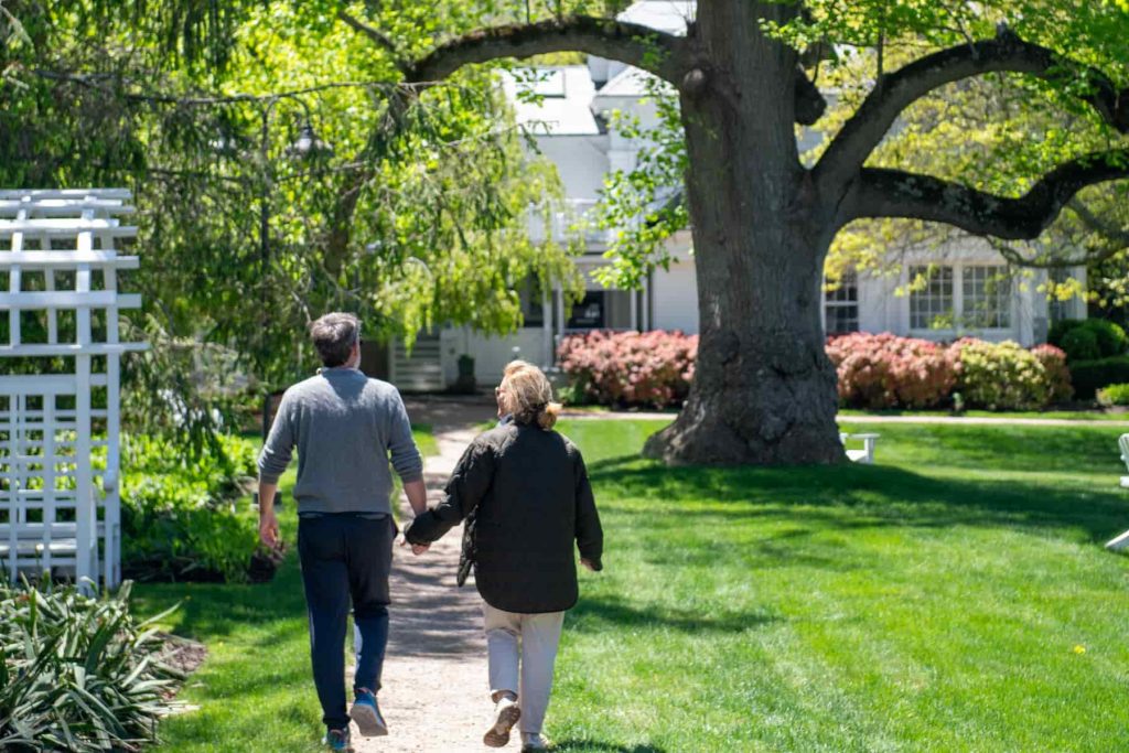 A couple walking on the grounds of our New England bed and breakfast during a romantic weekend getaway